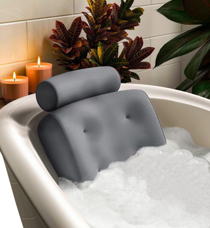 White Everlasting Comfort luxury bath pillow resting on the edge of a bathtub, featuring soft, cushioned support with ergonomic neck and shoulder design, surrounded by a relaxing spa-like setting.