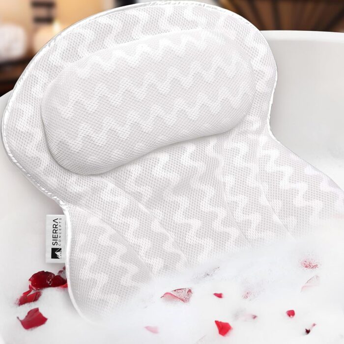 Sierra Concepts ergonomic bath pillow resting on the edge of a bathtub, showing its contoured design and soft cushioning for neck and shoulder support during a spa-like bath experience.