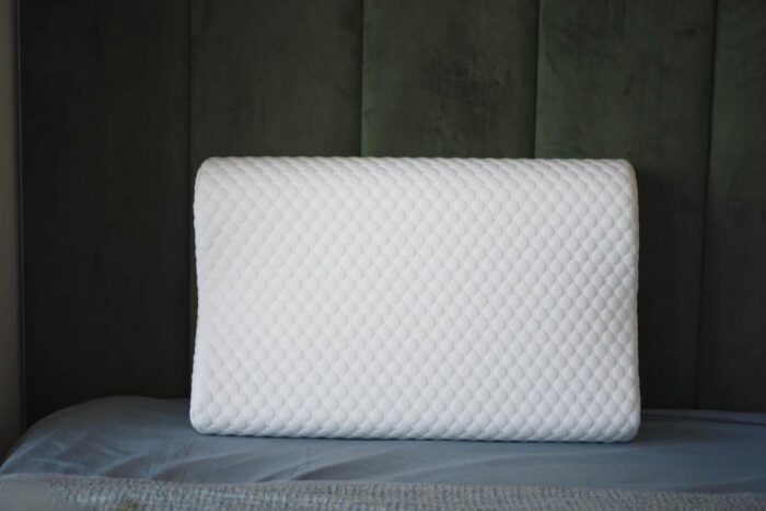 Orthopedic pillow on a bed