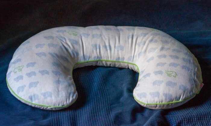 baby nursing pillow on a blue fabric background