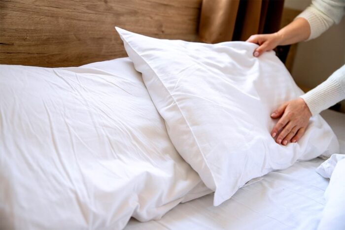 Bedroom setup highlighting a supportive pillow for improved neck alignment and restful sleep